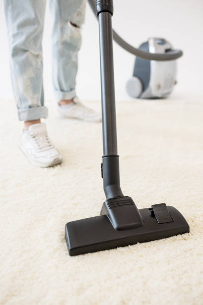 istock Woman vacuuming carpet 656648430
