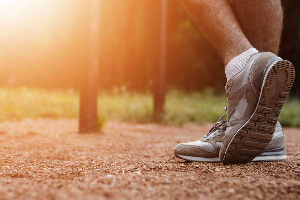 istock Athletic runner preparing for morning workout in the park, lens flare 656649798