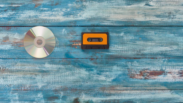 istock Cd disk and audio tape on an old vintage blue color background 656653420