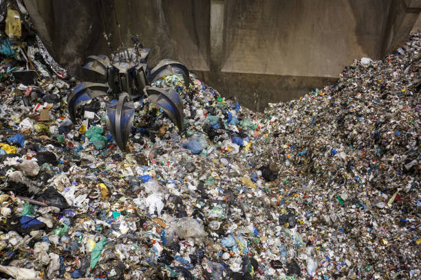 istock Mechanical claw hand grabbing pile of mixed waste 656653628