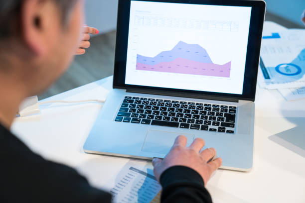 istock Hands working on a laptop computer with financial reports on the screen 656656204