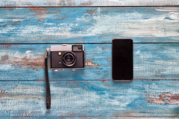 istock Old and new camera phone on the vintage background 656656218