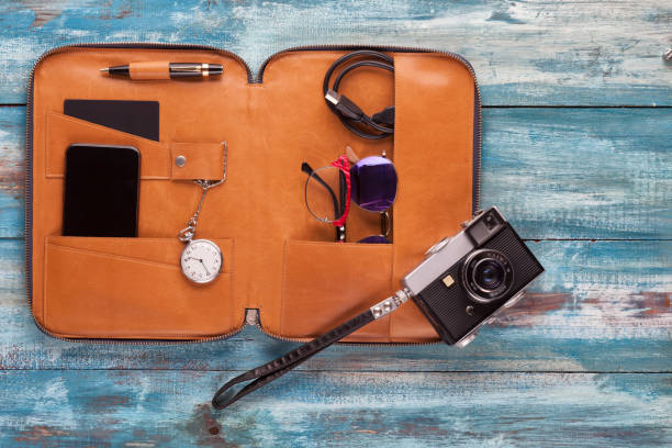 istock Business Small pouch with an old clock. a mobile phone, a camera, and pen 656656578