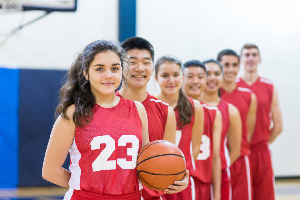istock Mixed gender high school basketball team posing 656659254
