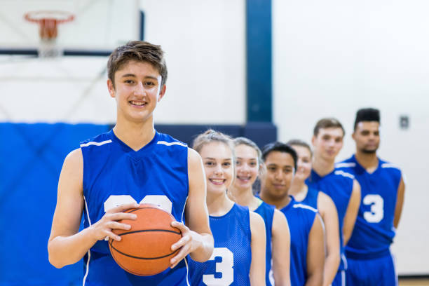 istock Mixed gender high school basketball team posing 656659258