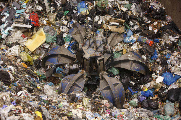 istock Mechanical claw hand grabbing pile of mixed waste 656661790