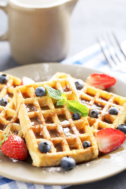 istock Homemade waffles with berries in plate on grey table 656662610