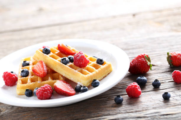 istock Homemade waffles with berries in plate on grey wooden table 656662794