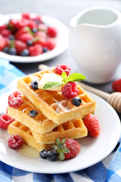 istock Homemade waffles with berries in plate on grey table 656662832