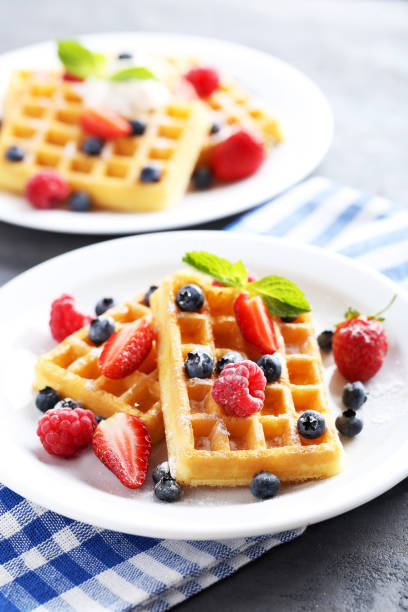 istock Homemade waffles with berries in plate on grey table 656664914