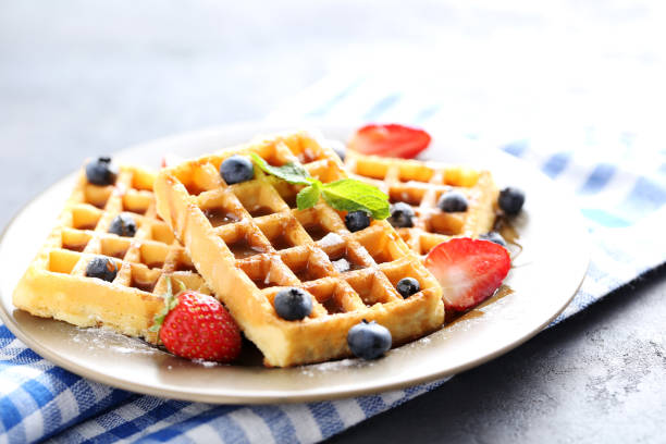 istock Homemade waffles with berries in plate on grey table 656665130