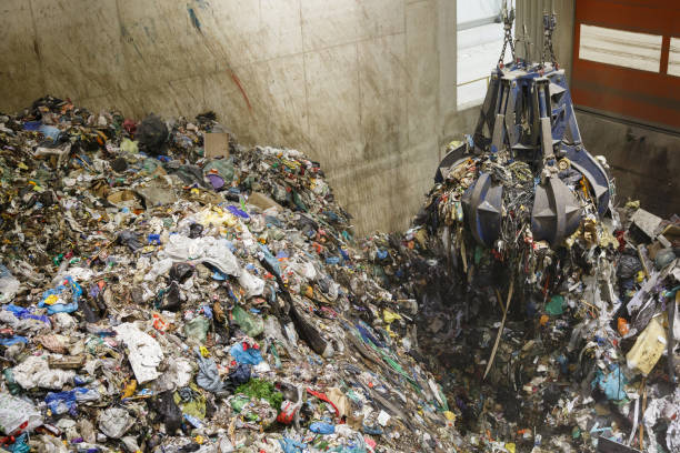 istock Mechanical claw hand grabbing pile of mixed waste 656665188