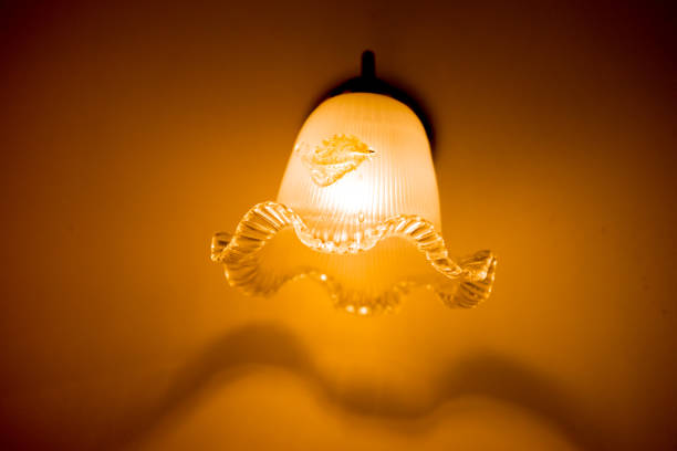 istock Ceiling lamp on wall in home at night 656666356