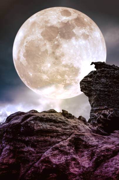 istock Boulder against sky with clouds and full moon at night. 656673702