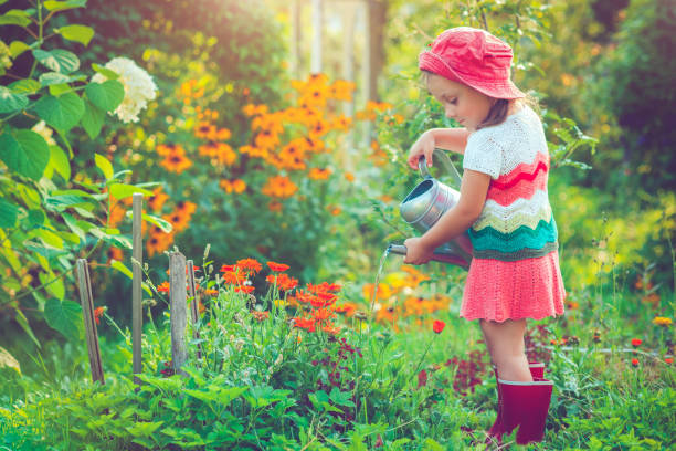 happy little girl in garden - watering place imagens e fotografias de stock