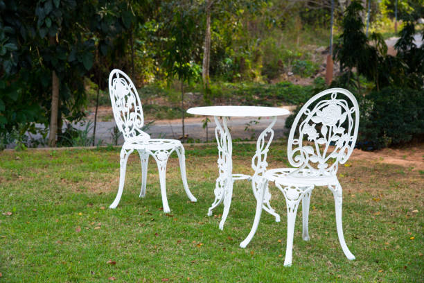 istock Set of white chairs and table in garden 656685140