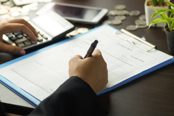 istock hand writing on paper with coins on table 656685832