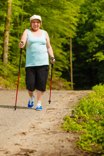 istock Senior woman practicing nordic walking in park 656688836