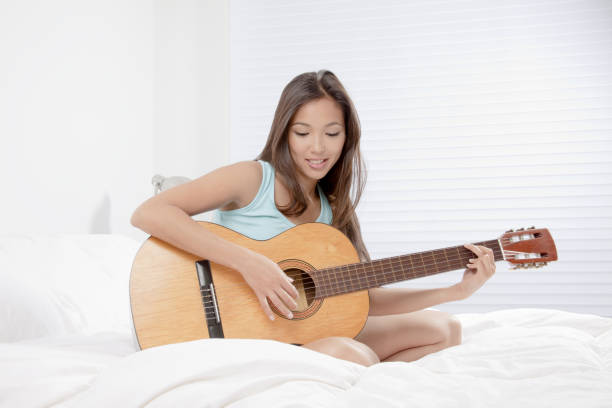 istock Young woman playing the guitar 656689442