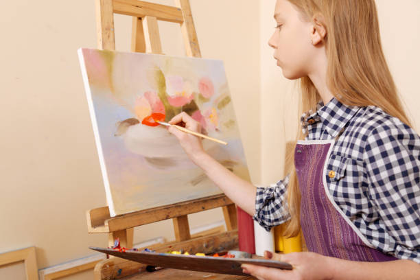 istock Charming young girl using pallet in the art school 656692356