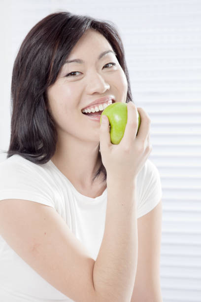 istock Young woman eating Apple 656692686