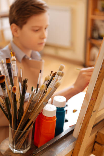 istock Concentrated kid having art lesson at school 656693132