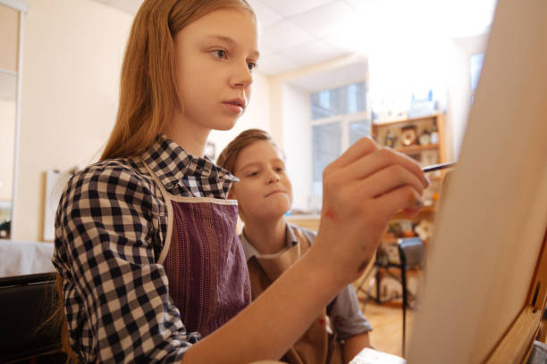istock Concentrated children painting at school 656699272