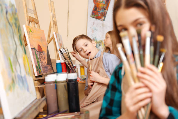 istock Merry kids having fun during the art lesson 656700312
