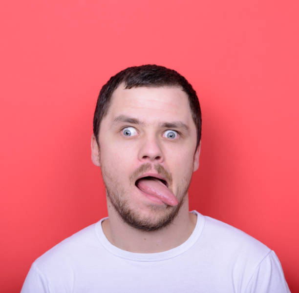 istock Portrait of man with funny face against red background 656700568
