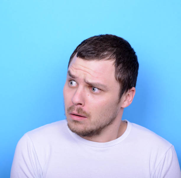istock Portrait of man with dusgusted gesture against blue background 656700690