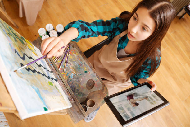 istock Concentrated girl painting in the art studio 656700980