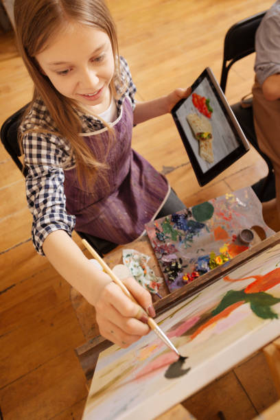 istock Charming girl making the art reproduction at school 656701062