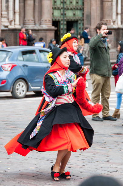 Cusco, Peru – April 15, 2016: A dancer at a traditional public dance festival in the Plaza Mayor Del Cusco in Cusco, Peru. Pedestrians visible in the background.