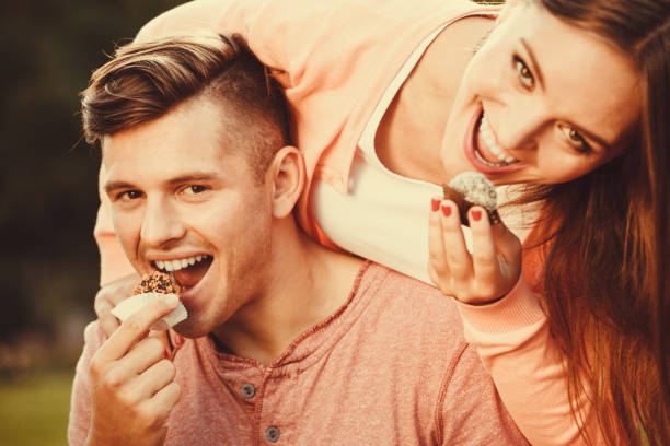 istock Lovely couple eating cupcakes. 656710652