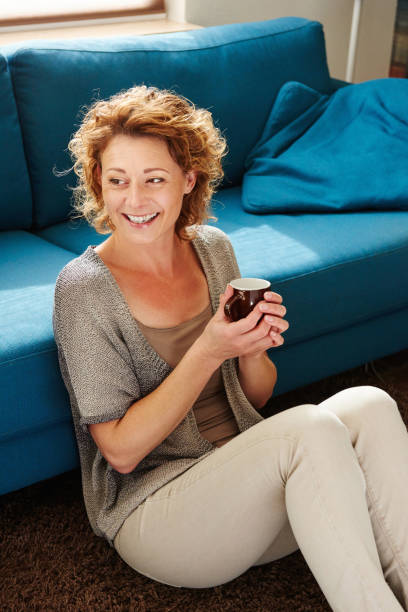 istock Happy older woman at home holding coffee mug 656711242