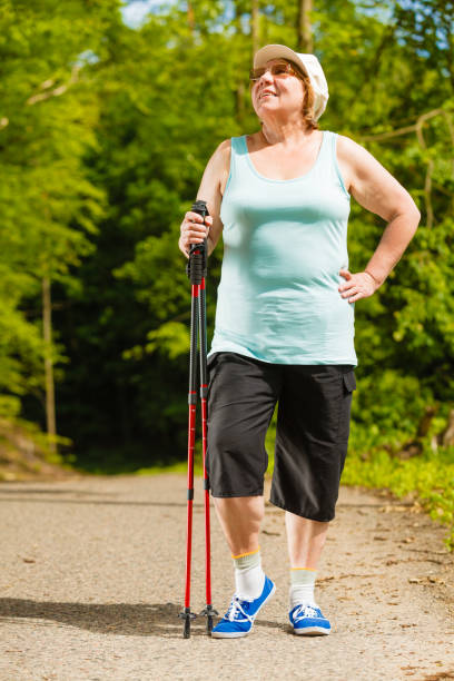 istock Senior woman practicing nordic walking in park 656722526