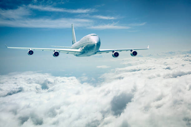 istock commercial airplane flying over the clouds 656734036