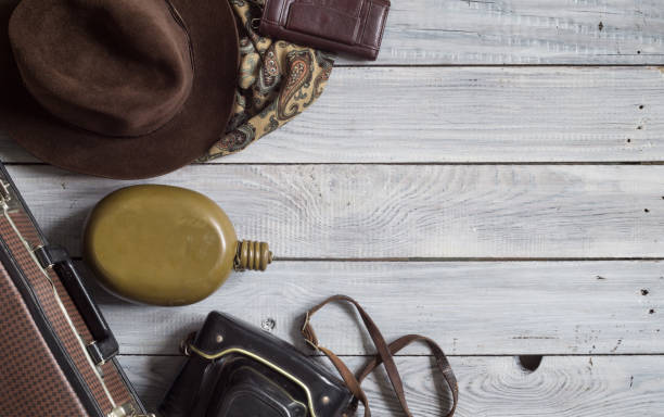 istock Man's hat and retro accessories for travel on a white painted wo 656736704