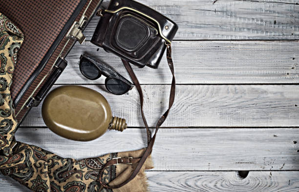 istock Man's hat and retro accessories for travel on a white painted wo 656736878