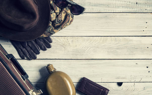 istock Man's hat and retro accessories for travel on a white painted wooden surface 656740182