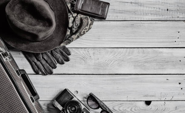 istock Man's hat and retro accessories for travel on a white painted wooden surface 656740206