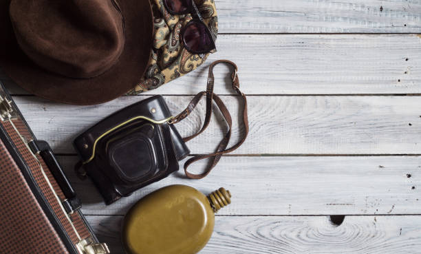 istock Man's hat and retro accessories for travel on a white painted wooden surface 656740310