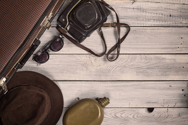 istock Man's hat and retro accessories for travel on a white painted wooden surface 656740524