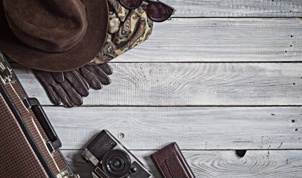 istock Man's hat and retro accessories for travel on a white painted wooden surface 656740588