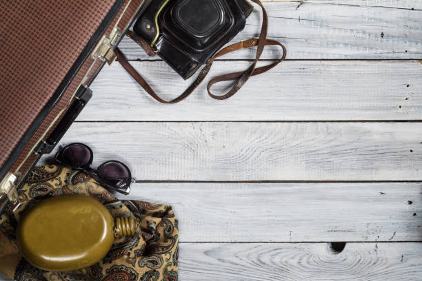 istock Man's hat and retro accessories for travel on a white painted wooden surface 656740676
