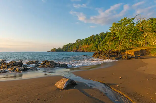 Sunset along the Pacific Ocean coast and jungle of Costa Rica at the entrance of Corcovado national park at sunset.