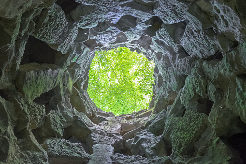 Looking up the outside trapped from inside a stone well