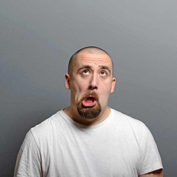 istock Portrait of a man making funny face against gray background 656751214
