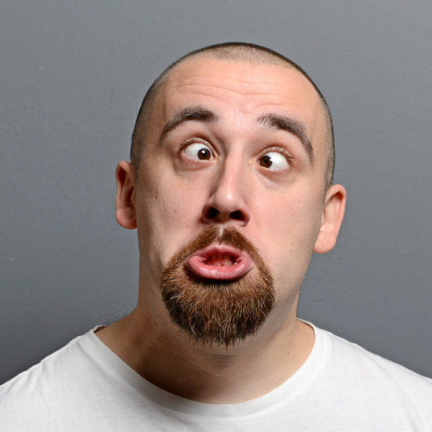 istock Portrait of a man making funny face against gray background 656751248