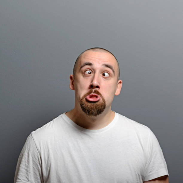 istock Portrait of a man making funny face against gray background 656751252